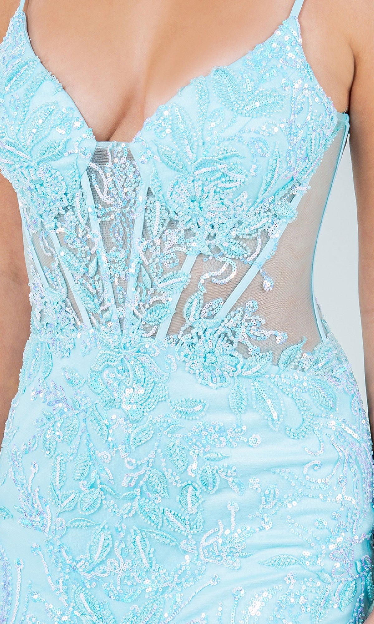 Close-up of a person wearing the Cinderella Couture 8276J Long Mermaid Prom Dress featuring light blue sequins, bead floral patterns, sheer mesh panels, and thin straps.